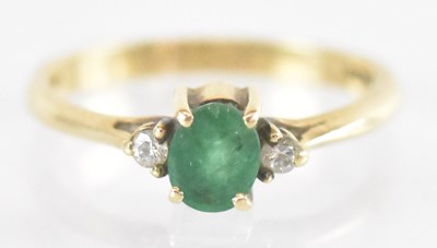 Lot 1290 - A 9ct yellow gold emerald and diamond set ring,...