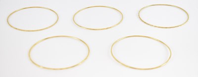 Lot 1292 - Five yellow metal bangles, diameter of each...