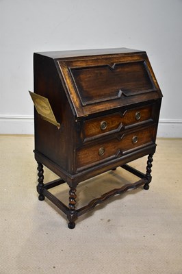 Lot 194 - A 1920s oak bureau, with fall front above two...