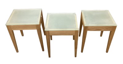 Lot 80 - Three modern light oak framed side tables with...