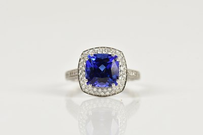 Lot 1276 - An 18ct white gold diamond and tanzanite dress...