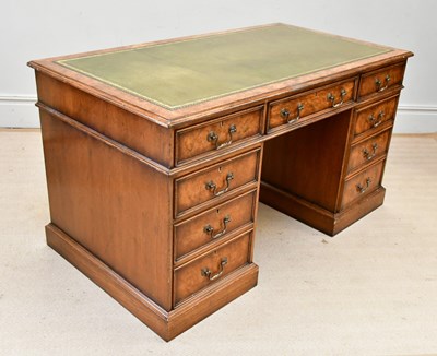 Lot 27 - A reproduction burr walnut kneehole desk, with...