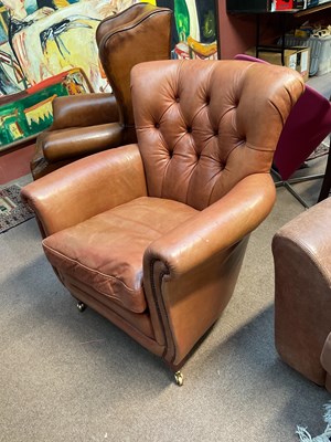 Lot 52 - A modern brown leather tub chair with button...