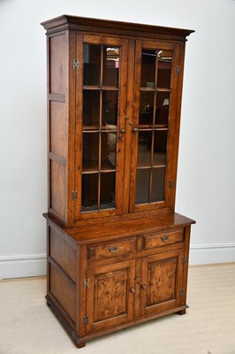 Lot 28 - A reproduction oak cabinet with moulded...