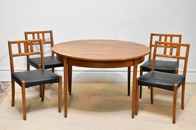 Lot 13 - A mid century teak extending circular dining...