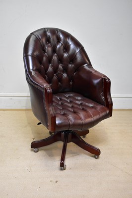 Lot 40 - A good reproduction brown leather swivel...