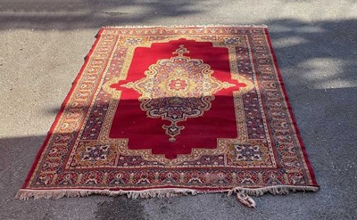 Lot 292 - A red ground Caucasian wool rug, worked with...