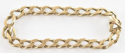 Lot 1258 - A yellow metal flat Cuban link bracelet,...