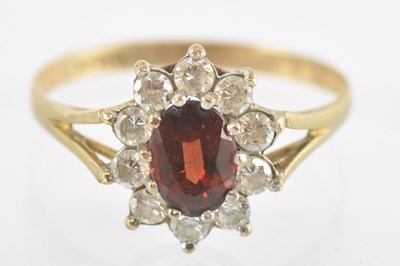 Lot 1351 - A 9ct yellow gold red and white stone set ring,...