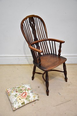 Lot 133 - A 19th century elm seated Windsor elbow chair...