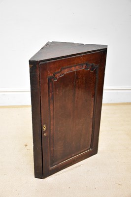 Lot 112 - A Georgian oak straight-front corner cupboard,...