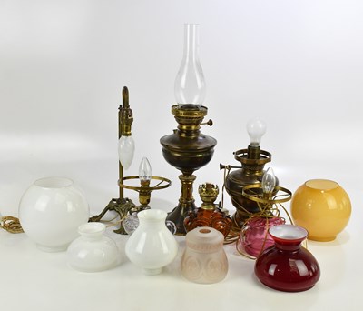 Lot 635 - An assortment of oil lamps and shades...