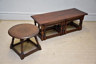 Lot 84 - A nest of three oak tables and a circular...