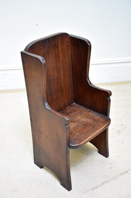 Lot 85 - An oak wingback child’s chair.