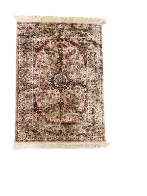 Lot 116 - A Persian pink ground silk floral decorated...