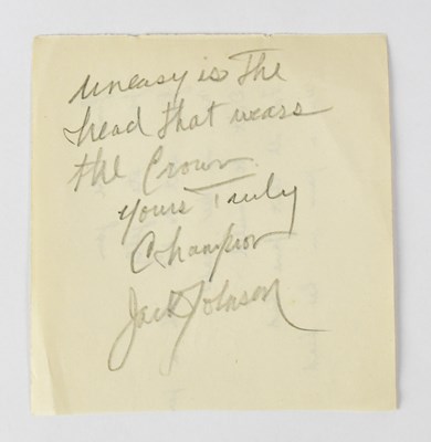 Lot 414 - JACK JOHNSON; a torn page from an autograph...