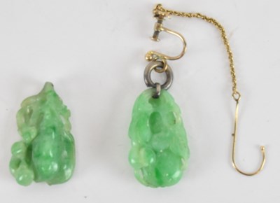 Lot 1281 - A pair of Chinese carved green jade pendants,...