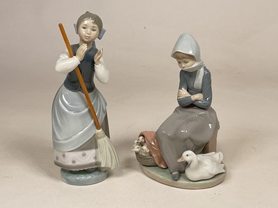 Lot 249 - LLADRO; two figures comprising a girl standing...