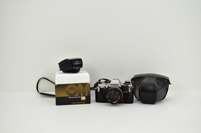 Lot 186 - OLYMPUS; a cased model OM10 SLR 35mm camera,...