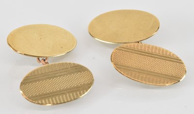 Lot 1324 - A pair of 9ct yellow gold oval cufflinks, with...