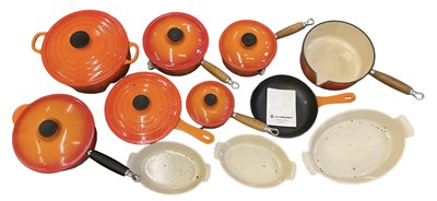 Lot 546 - LE CREUSET; a group of orange cast iron pans...