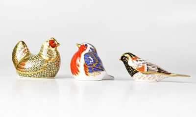 Lot 273 - ROYAL CROWN DERBY; three Imari paperweights,...