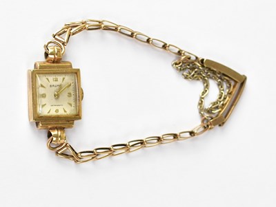 Lot 667 - BAUM; a 9ct yellow gold wristwatch, the white...