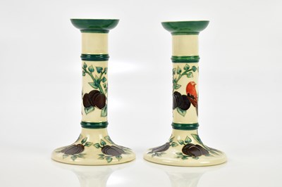 Lot 846 - MOORCROFT; a pair of cylindrical candlesticks...