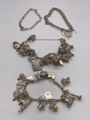 Lot 1313 - Two silver charm bracelets and two further...