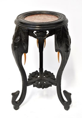 Lot 69 - An ebonised jardinière stand with rouge marble...