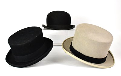 Lot 440 - Five hats comprising a Moss Bros grey top hat,...