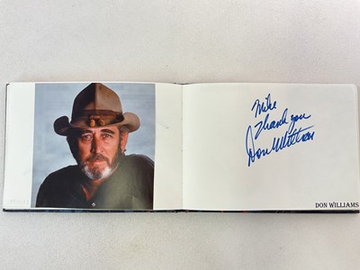 Lot 1594 - An autograph album with pages signed by...