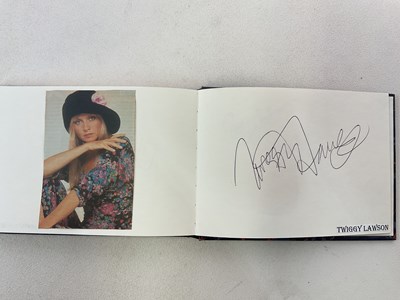 Lot 1656 - An autograph album with pages of signatures...