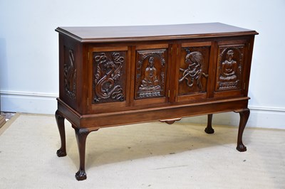 Lot 57 - A mahogany cabinet, the four doors carved with...