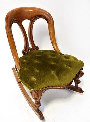 Lot 17 - A Victorian mahogany rocking chair with arched...