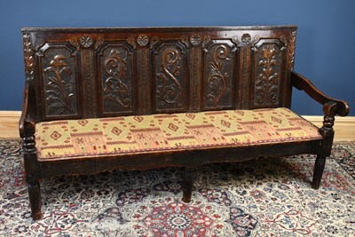 Lot 2935 - An 18th century carved oak settle, the...