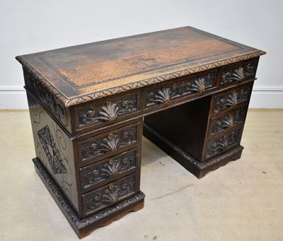 Lot 87 - A Victorian carved oak pedestal desk, the nine...