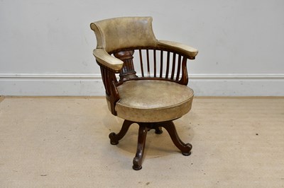 Lot 93 - An oak office desk chair, with leather...