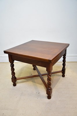 Lot 105 - A 1920s oak draw-leaf dining table on barley...