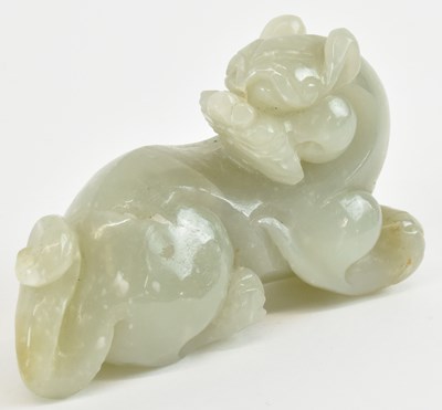 Lot 1044 - A Chinese carved green jade figure of a...