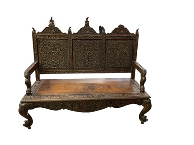 Lot 1006 - An Anglo-Indian type profusely carved bench,...