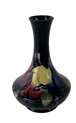 Lot 647 - MOORCROFT; a blue ground floral decorated vase,...