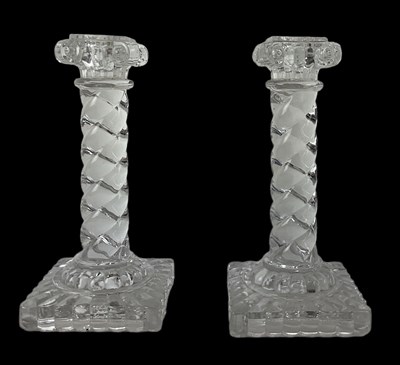 Lot 675 - BACCARAT; a pair of crystal glass candlesticks,...