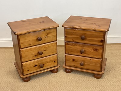 Lot 862 - A pair of pine bedside drawers on bun feet,...