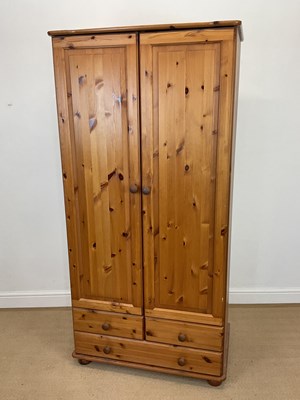 Lot 876 - A pine double wardrobe with two short and one...