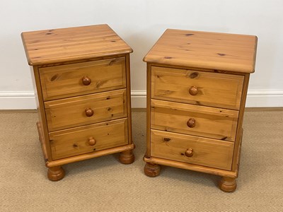 Lot 860 - A pair of pine bedside drawers on bun feet,...