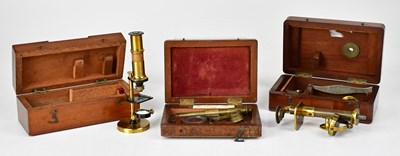 Lot 150 - Three small travelling cased brass microscopes,...