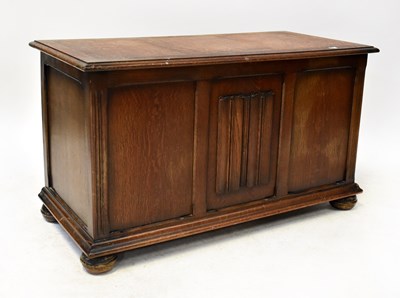 Lot 40 - An early 20th century oak coffer with linen...