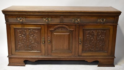 Lot 62 - A Victorian oak dresser base with two shaped...