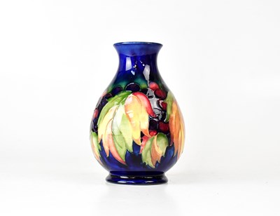 Lot 268 - MOORCROFT; a baluster vase in the 'Grape and...